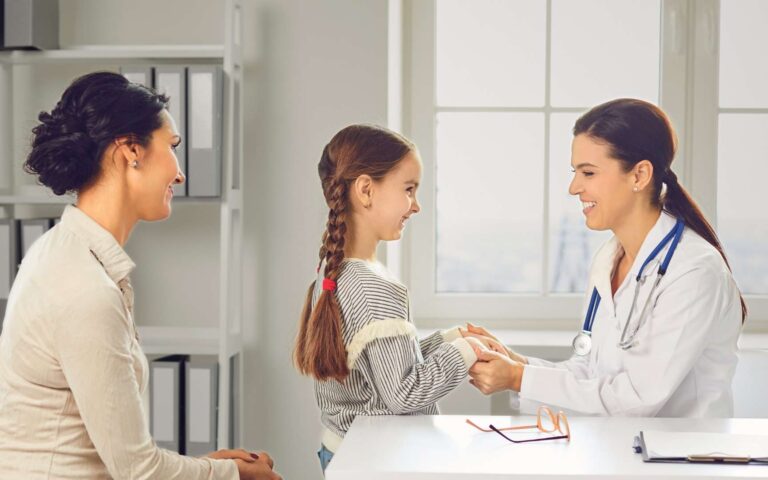 niña siendo revisada por un doctor
